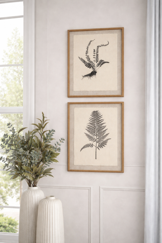 Framed botanical prints on a wall with decorative vases and plants.