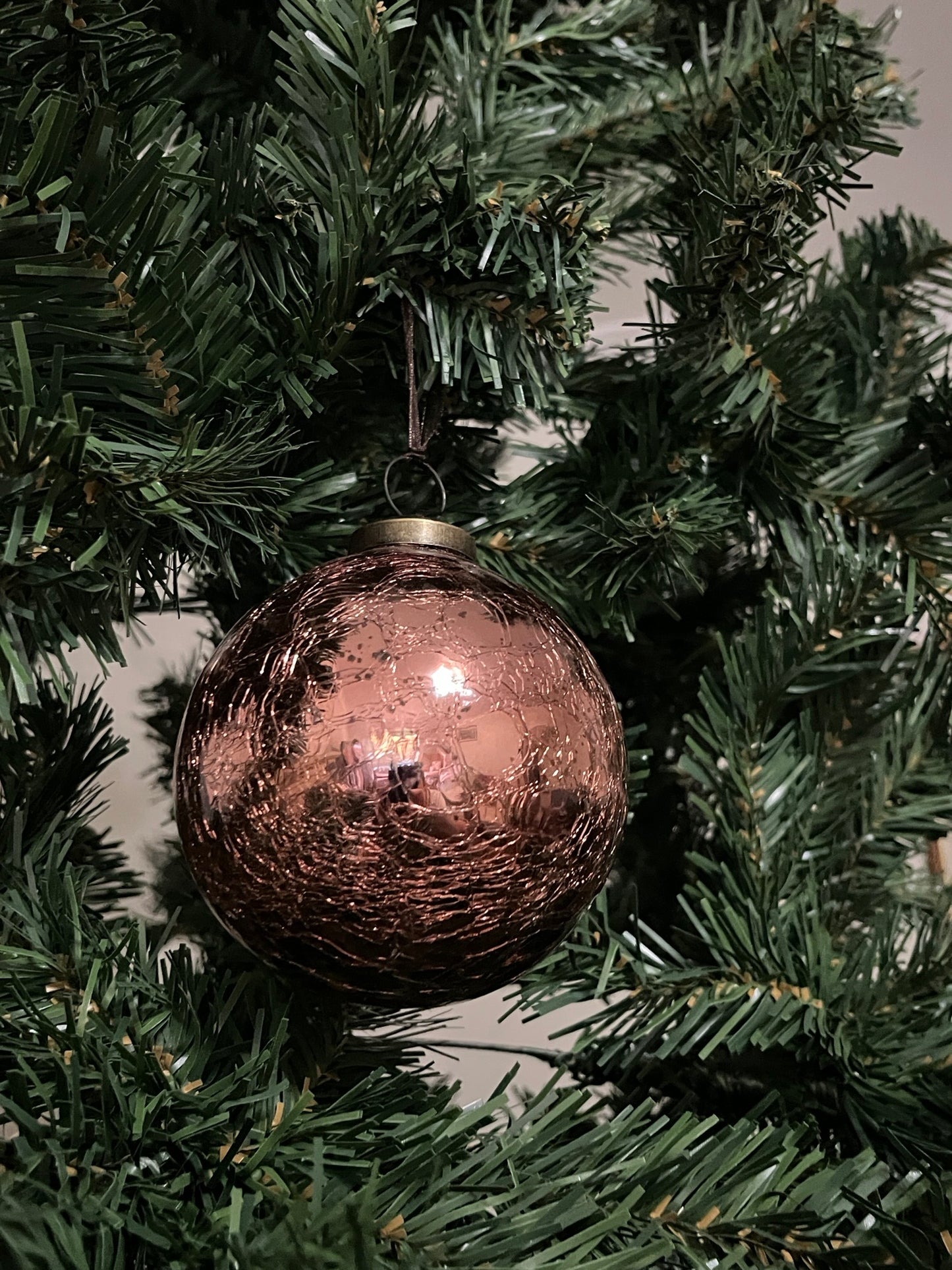 Rust Glass Crackle Christmas ornament on a green tree